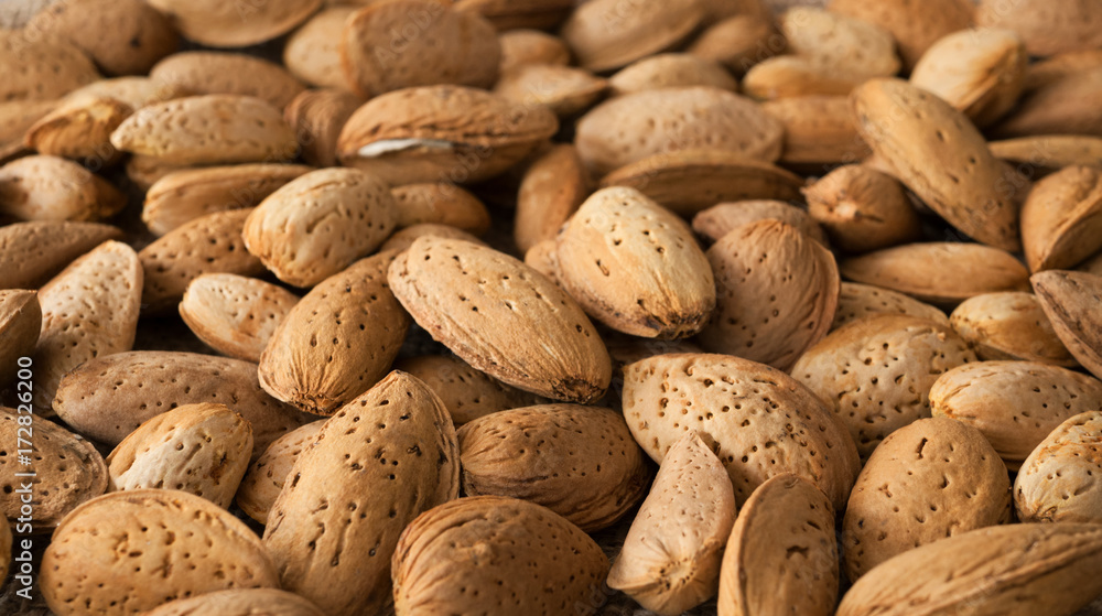 Almond nut in shell as food background. Organic raw almond for vegans Almond nut in shell as food background. Organic raw almond for vegans