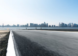 empty asphalt road with cityscape of modern city
