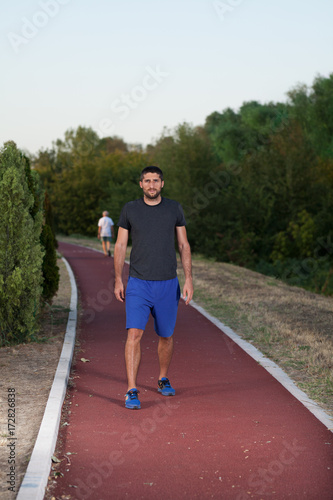 Young man running on the running track