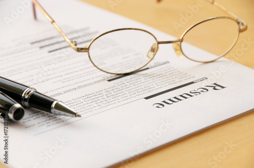 resume paper and pen,glasses on the table