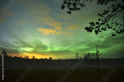 An aurora (polar lights or northern lights) with sunrise in northern Finland © Lukas