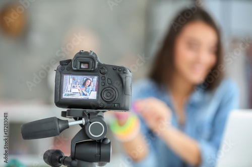 Young female blogger on camera screen
