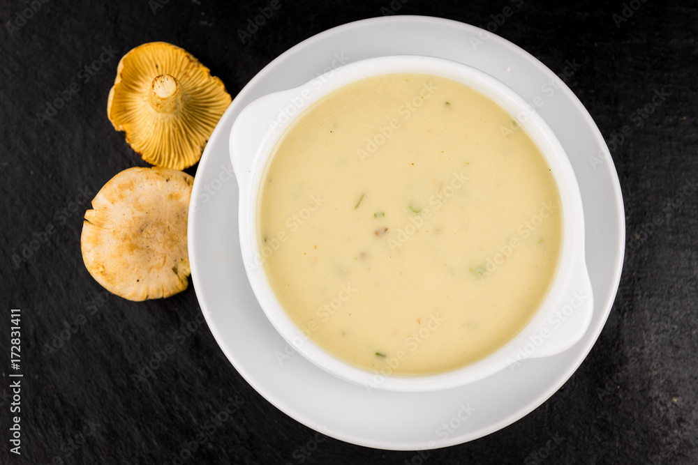 Rustic slate slab with Chanterelle Soup, selective focus Rustic slate slab with Chanterelle Soup, selective focus