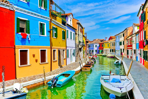 View of the colorful Venetian houses along the canal at the Islands of Burano in Venice. © Javen