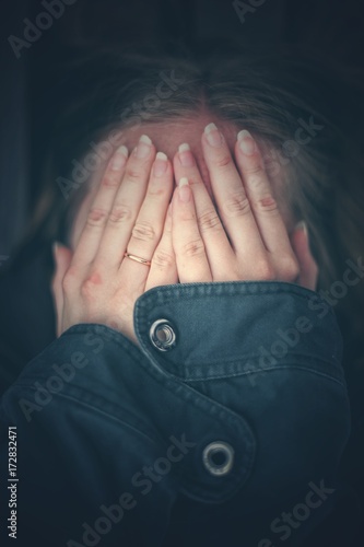 The girl covered her face with her hands