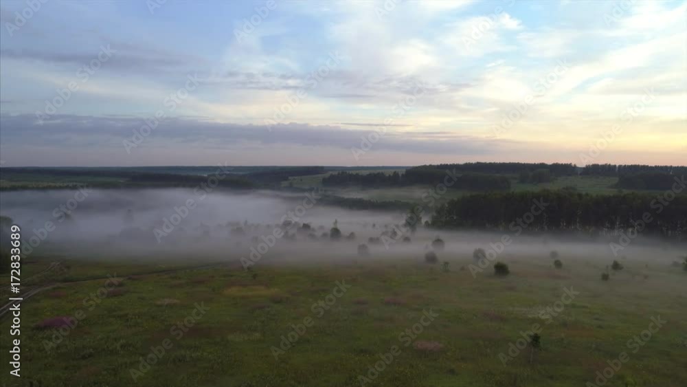 Aerial view ,high flying above fields, forest and lake at misty morning Aerial view ,high flying above fields, forest and lake at misty morning