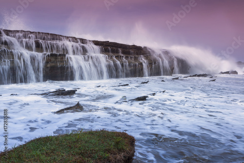 Beautiful Tanjung Layar Beach, Sawarna during sunset in Banten, West Java Indonesia photo