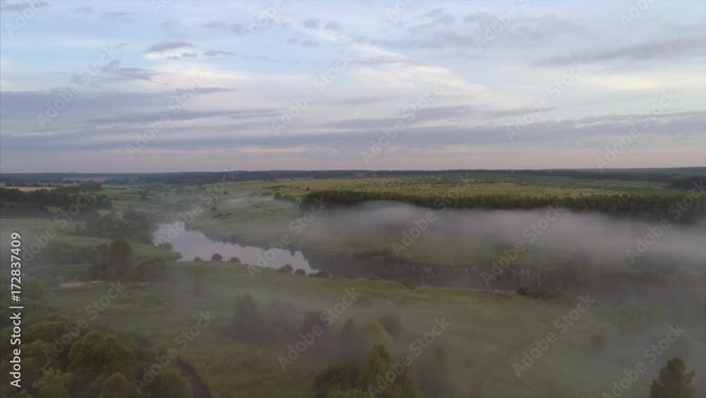 Aerial view ,high flying above fields, forest and lake at misty morning Aerial view ,high flying above fields, forest and lake at misty morning