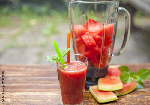glass of pure watermelon Juice and Shaker on daylight