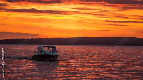 Boat sails at sunset in Lake Onega