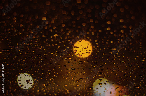 Rain drops on windows with abstract lights