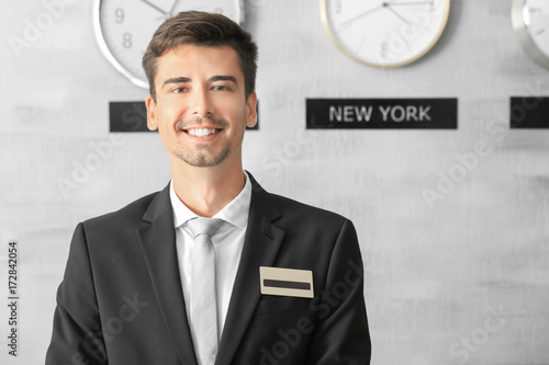 Male receptionist working i...