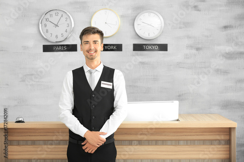 Male receptionist working i...