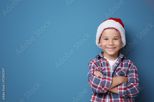 Cute boy in Santa hat on co...