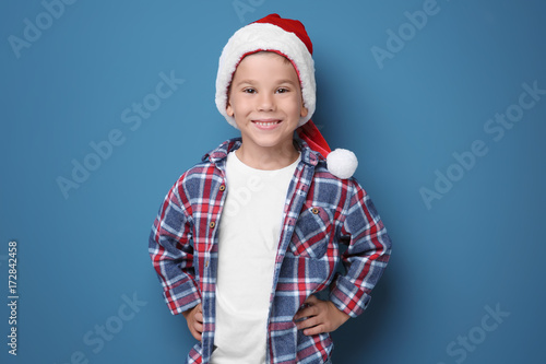 Cute boy in Santa hat on co...