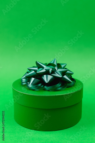 Green gift on green background
