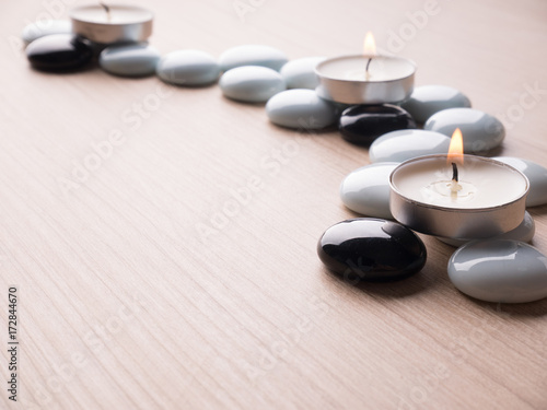 Spa still life concept Close up of spa theme on wood background with burning candle and bamboo leaf and flower