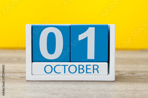 October 1st . First day, October 1 blue wooden calendar on yellow abstract background. Autumn day photo