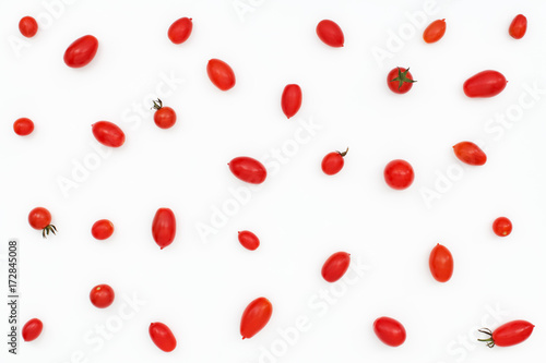 Pattern of red ripe mini tomatoes on white backround. Top view