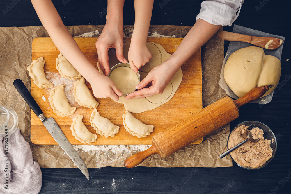 Mom and daughter preparing dumplings in the kitchen
