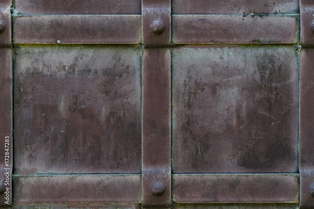 Background of wrought iron with rivets and metal stripes. Dirty steel texture. The background of the castle gate.