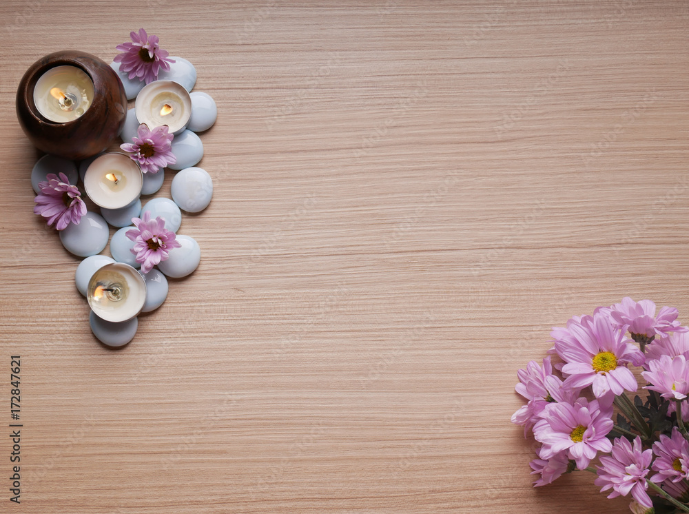 Spa still life concept,Close up of spa theme on wood background with burning candle and bamboo leaf and flower Spa still life concept,Close up of spa theme on wood background with burning candle and bamboo leaf and flower