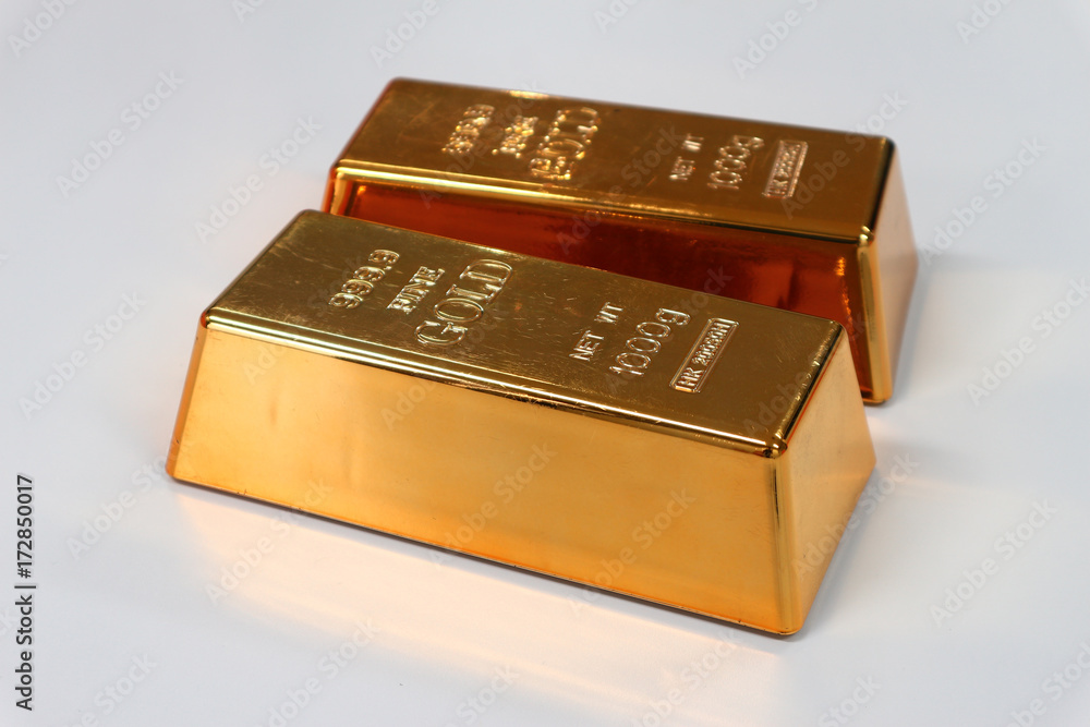 Two gold bar on white table Two gold bar on white table