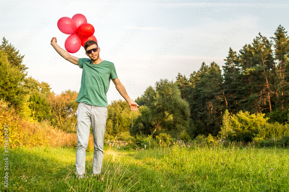 the young man with balloons. Concept happiness the young man with balloons. Concept happiness