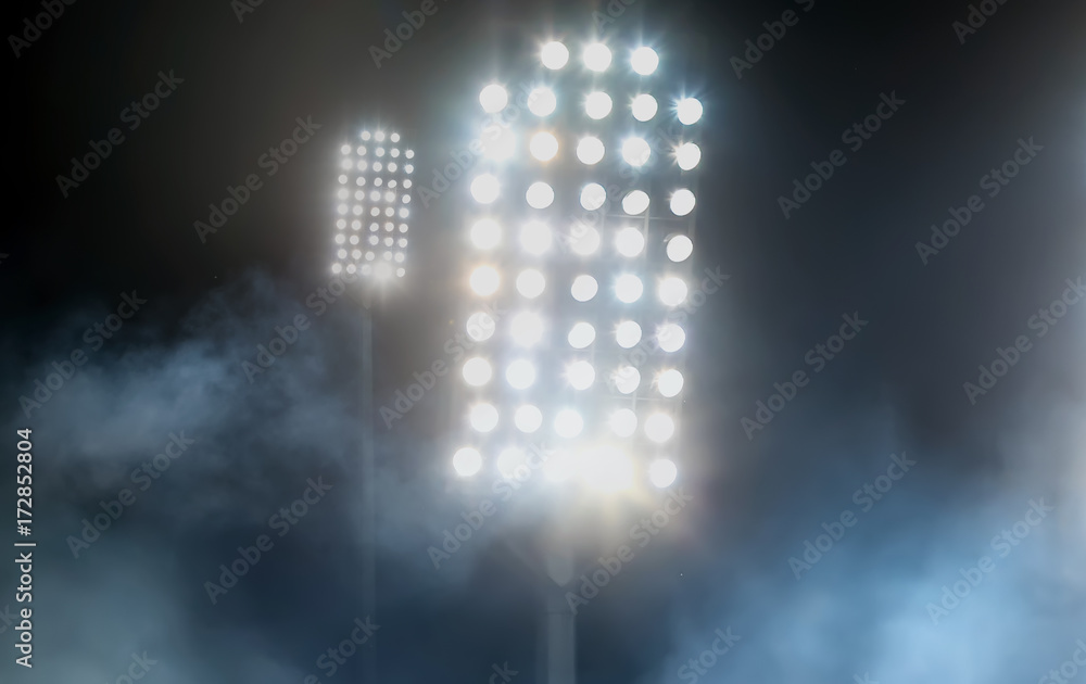 stadium lights and smoke against dark night sky background stadium lights and smoke against dark night sky background