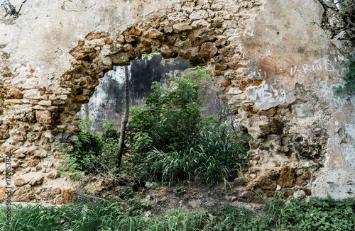 Hole in wall of abandoned stone building
