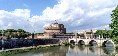 Panoramic view of the castle of San Angelo and the bridge of San Angelo on the river Tiber, from the street called "Lungotevere in Sassia". With a dramatic sky with clouds