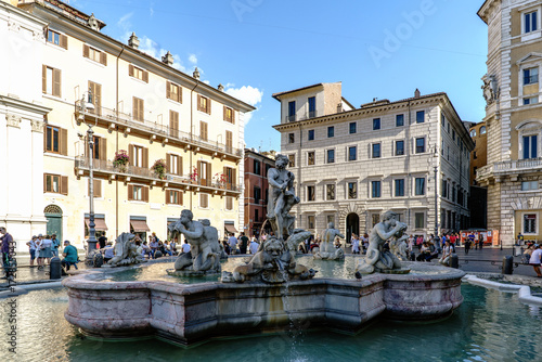 Rome, Lazio, Italy. July 25, 2017: View of Neptune Fountain, located in the famous square called "Navona". With people and a blue sky