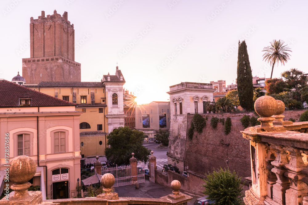 © peizais - Ancient Roman constructions seen from the stairs of the church of Santo Domenico and Sisto with the sun backlit at dusk in Rome, Italy