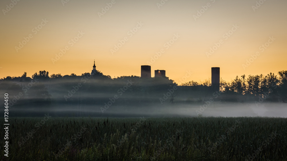 Sunrise during the fog over the castle  in Czersk, Poland