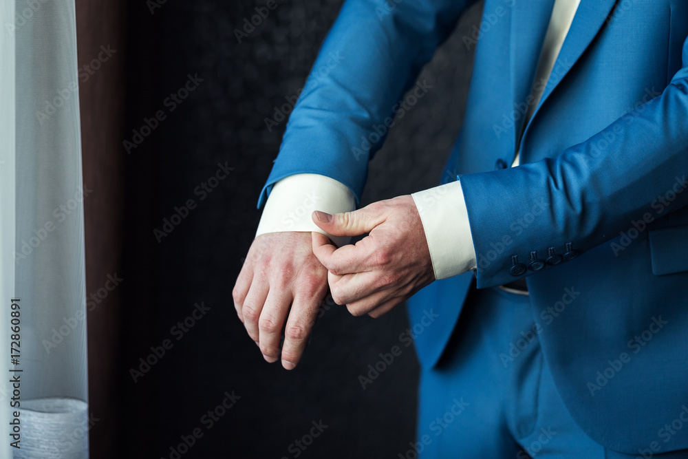 Obraz premium Businessman wears a jacket.Politician, man's style,male hands closeup, American, European businessman, business, fashion and clothing concept