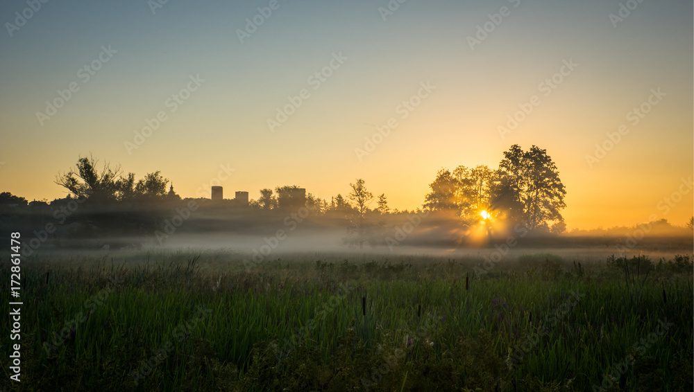 Fototapeta premium Sunrise during the fog over the castle in Czersk, Poland