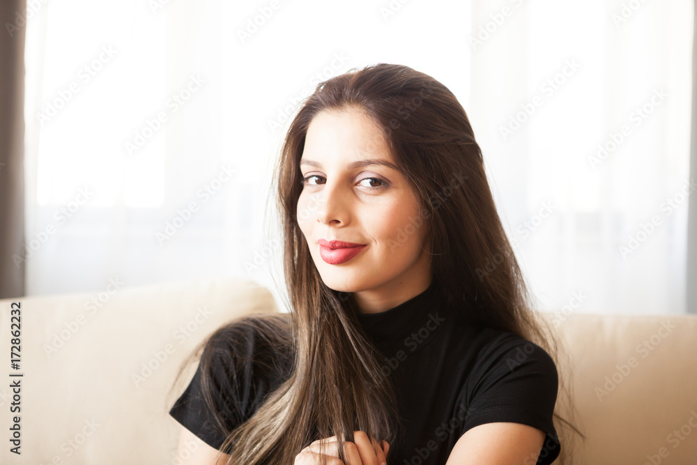 Portait of Beautiful gorgeous young woman relaxing in the living room. Having a good time home Portait of Beautiful gorgeous young woman relaxing in the living room. Having a good time home
