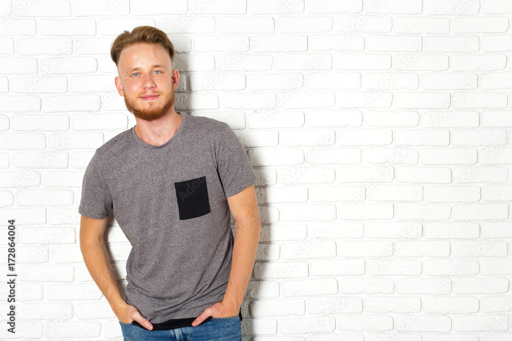 Young Sexy Man Against a White Brick Wall Young Sexy Man Against a White Brick Wall