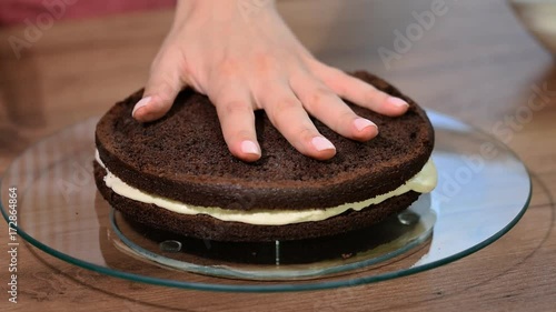 Assembling the cakes of chocolate biscuit. Cooking biscuit cake photo