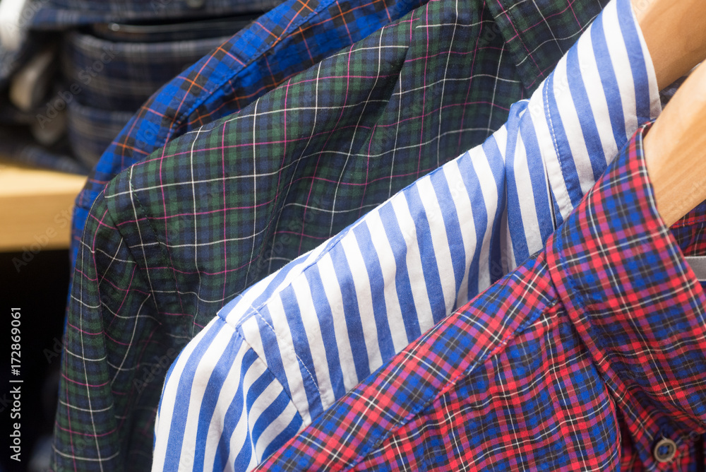 Mens shirts on hangers in modern fashion boutique