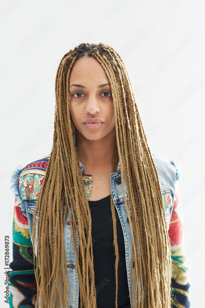 Portrait of a beautiful young African American  woman with long braids on white background