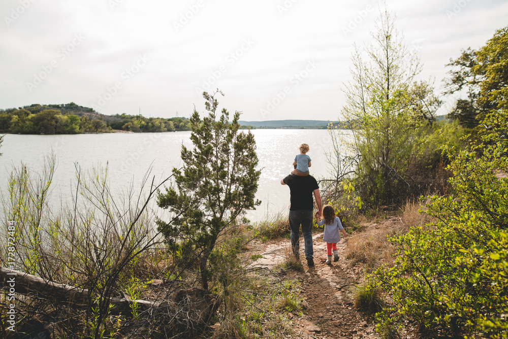 Dad walking with two children Dad walking with two children