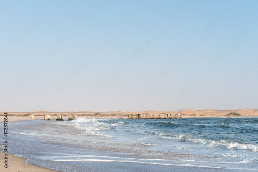 Pillars of old railroad bridge over the mouth Swakop River