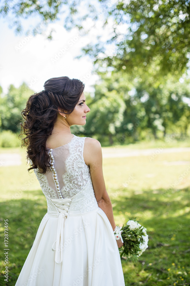 Beautiful bride outdoors on the meadow on a wedding day. Joyful moment of happiness Beautiful bride outdoors on the meadow on a wedding day. Joyful moment of happiness