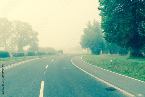 Highway in the early morning in the fog