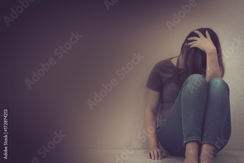 Quadro em tela sadness young woman sitting on wood floor looking at empty dark area feeling unhappy and afraid on white wall background with battered abused woman concept