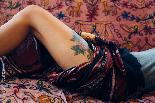 Woman revealing her tattooed thigh