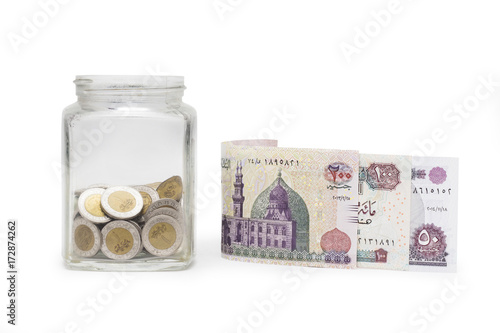 Egyptian Pounds and Coins in Jar, Egyptian Banknotes , Isolated on White Background photo