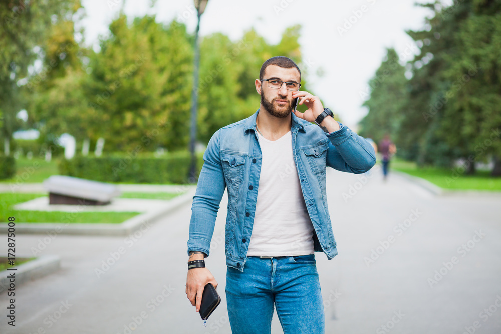 Handsome fashionable fit man talking over telephone
