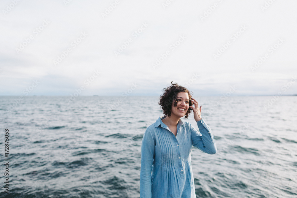 Portrait of young happy woman hanging out in near ocean Portrait of young happy woman hanging out in near ocean